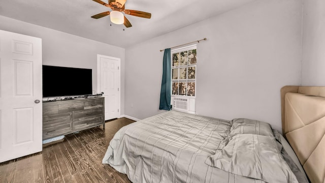 bedroom with dark wood-style floors, baseboards, and ceiling fan