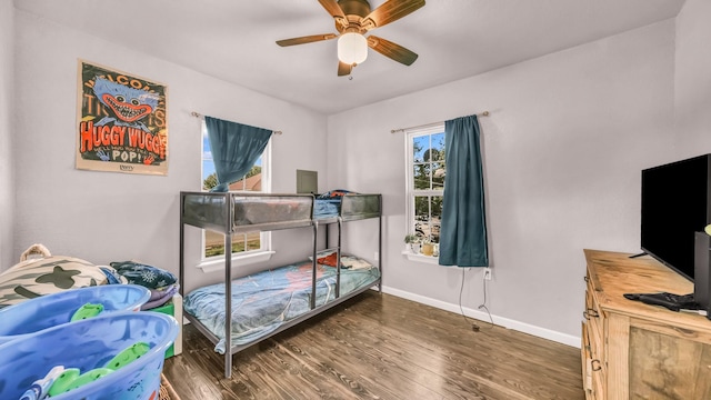 bedroom featuring wood finished floors, baseboards, and a ceiling fan