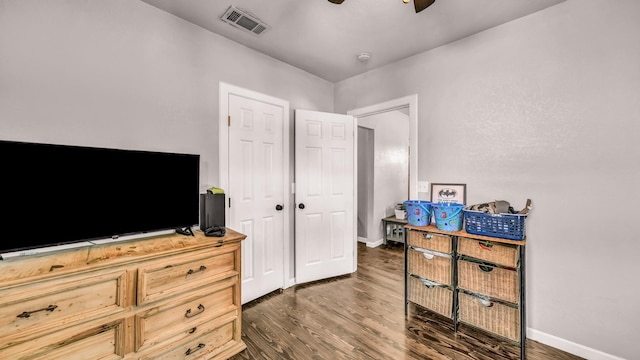 bedroom with dark wood-style flooring, baseboards, and a ceiling fan