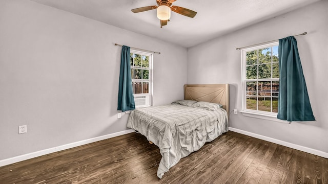 bedroom with baseboards, wood finished floors, and ceiling fan