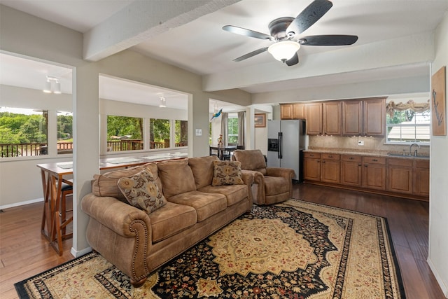 237 Ben Lacy Dr, Gun Barrel City, TX 75156 - living area featuring ceiling fan, dark wood-style floors, healthy amount of natural light, beamed ceiling, and baseboards