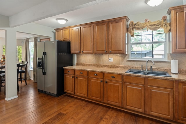 237 Ben Lacy Dr, Gun Barrel City, TX 75156 - kitchen with stainless steel fridge, a sink, brown cabinets, decorative backsplash, and dark wood finished floors