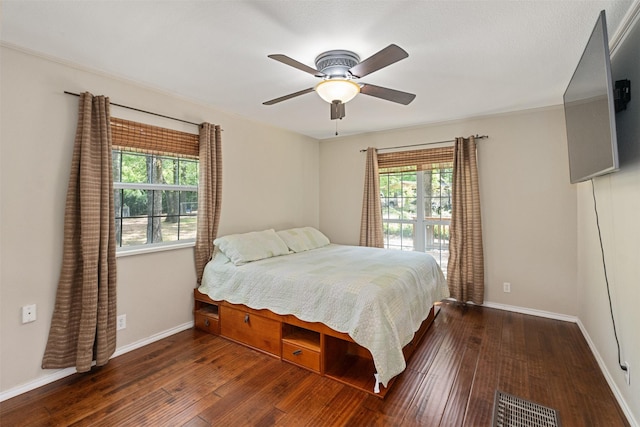 237 Ben Lacy Dr, Gun Barrel City, TX 75156 - bedroom featuring multiple windows, hardwood / wood-style flooring, baseboards, and a ceiling fan