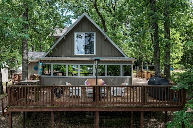 237 Ben Lacy Dr, Gun Barrel City, TX 75156 - rear view of house with board and batten siding, a wooden deck, a shingled roof, and a standing seam roof