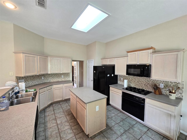 10908 Brandenberg Dr, Frisco, TX 75035 - kitchen featuring black appliances, backsplash, a sink, a kitchen island, and light countertops