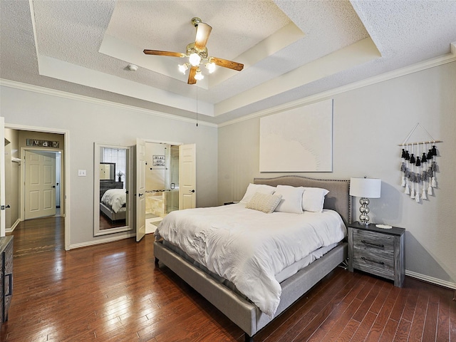 611 Falling Leaf Dr, Allen, TX 75002 - bedroom featuring a tray ceiling, hardwood / wood-style floors, baseboards, a textured ceiling, and crown molding