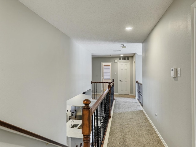 611 Falling Leaf Dr, Allen, TX 75002 - hallway featuring an upstairs landing, carpet flooring, baseboards, a textured ceiling, and recessed lighting