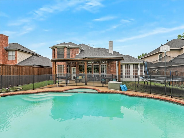 611 Falling Leaf Dr, Allen, TX 75002 - view of pool with a trampoline, a patio, a fenced backyard, and a pool with connected hot tub