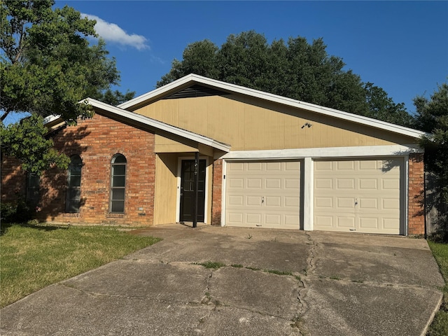 1029 Fox River Ln, Fort Worth, TX 76120 - ranch-style home with concrete driveway, a garage, brick siding, and a front yard