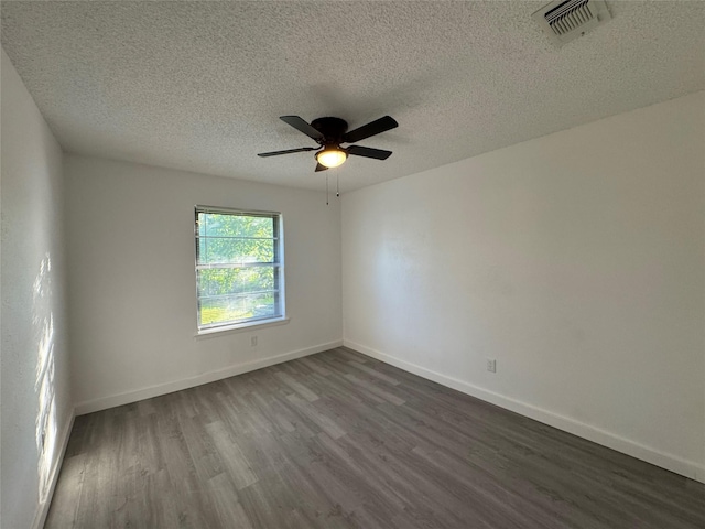 1029 Fox River Ln, Fort Worth, TX 76120 - empty room with dark wood-style flooring, a textured ceiling, a ceiling fan, and baseboards