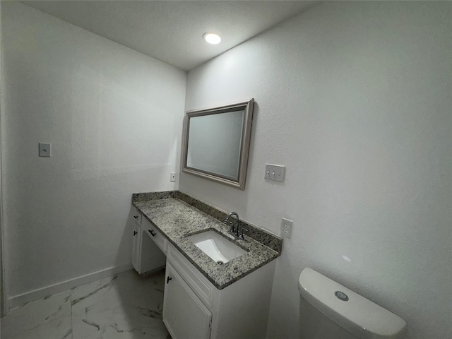 1029 Fox River Ln, Fort Worth, TX 76120 - bathroom featuring vanity, baseboards, marble finish floors, and toilet