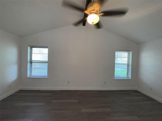 1029 Fox River Ln, Fort Worth, TX 76120 - empty room with plenty of natural light, lofted ceiling, dark wood finished floors, and baseboards