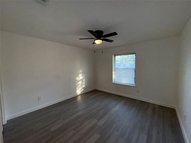 1029 Fox River Ln, Fort Worth, TX 76120 - unfurnished room featuring dark wood finished floors, baseboards, and a ceiling fan