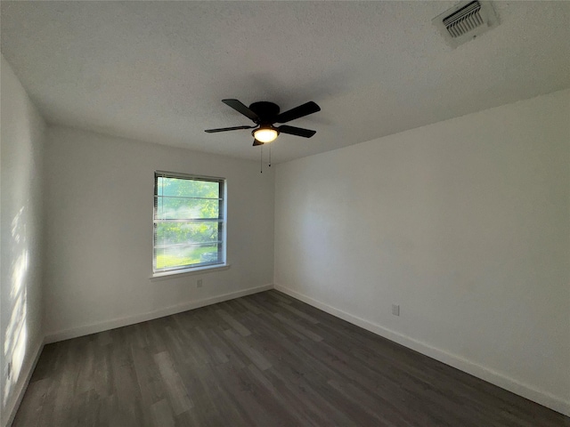 1029 Fox River Ln, Fort Worth, TX 76120 - empty room with dark wood finished floors, baseboards, ceiling fan, and a textured ceiling