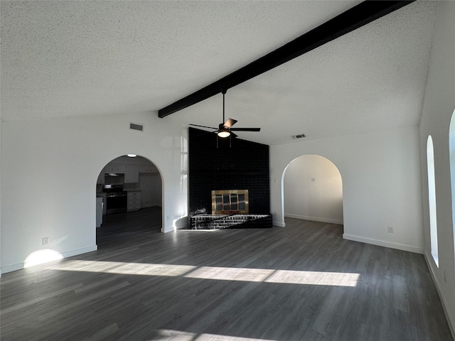 1029 Fox River Ln, Fort Worth, TX 76120 - unfurnished living room featuring a ceiling fan, a brick fireplace, a textured ceiling, wood finished floors, and baseboards
