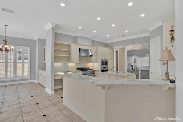 11911 Longfellow Cir, Shreveport, LA 71106 - kitchen featuring built in appliances, wall chimney range hood, crown molding, cream cabinets, and open shelves
