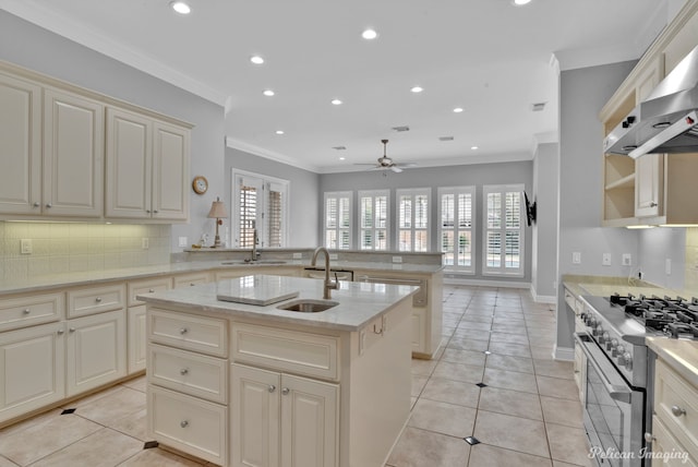 11911 Longfellow Cir, Shreveport, LA 71106 - kitchen featuring high end range, a sink, wall chimney exhaust hood, ornamental molding, and cream cabinetry