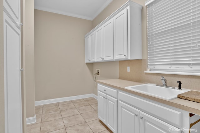 11911 Longfellow Cir, Shreveport, LA 71106 - clothes washing area featuring ornamental molding, cabinet space, light tile patterned flooring, baseboards, and hookup for a washing machine