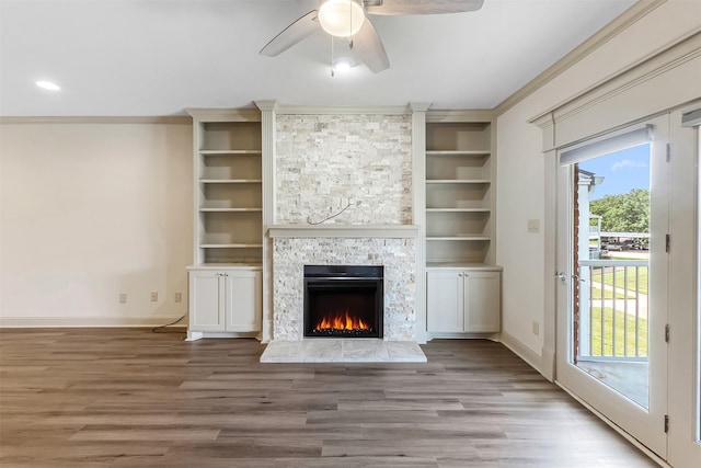 8511 Westover Ct Unit 235, Granbury, TX 76049 - unfurnished living room featuring baseboards, wood finished floors, a fireplace, ceiling fan, and ornamental molding