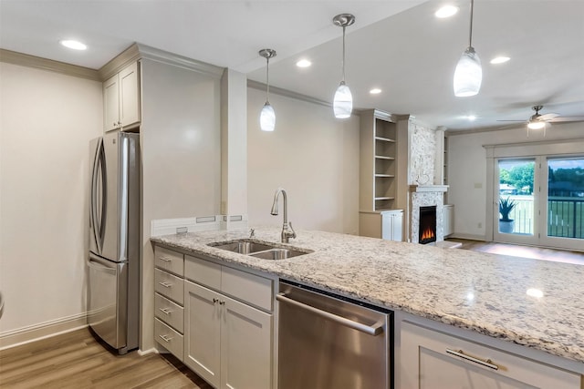 8511 Westover Ct Unit 235, Granbury, TX 76049 - kitchen with stainless steel appliances, a sink, light wood-type flooring, baseboards, and light stone countertops