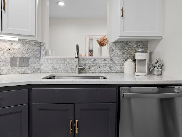 2633 Mccart Ave, Fort Worth, TX 76110 - kitchen with stainless steel dishwasher, a sink, tasteful backsplash, white cabinetry, and light stone counters