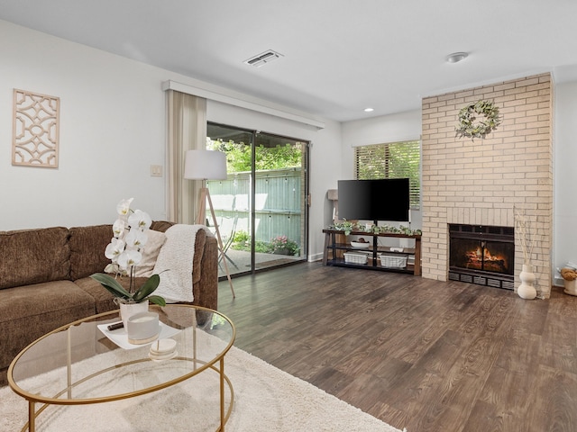 2633 Mccart Ave, Fort Worth, TX 76110 - living area featuring wood finished floors, a fireplace, and recessed lighting