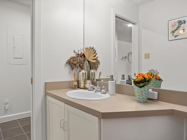 2633 Mccart Ave, Fort Worth, TX 76110 - bathroom with vanity, tile patterned flooring, electric panel, and baseboards
