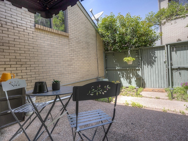 2633 Mccart Ave, Fort Worth, TX 76110 - view of side of home with a patio area, brick siding, and fence