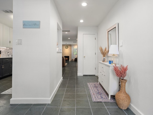 2633 Mccart Ave, Fort Worth, TX 76110 - hallway with dark tile patterned flooring, recessed lighting, and baseboards