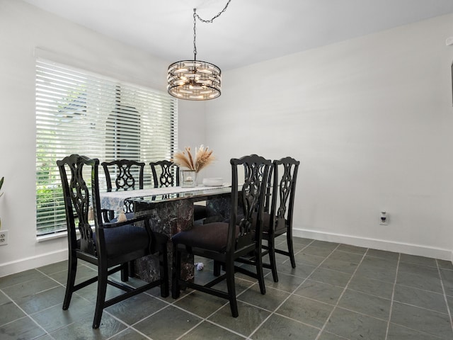 2633 Mccart Ave, Fort Worth, TX 76110 - dining room featuring a chandelier, plenty of natural light, and baseboards