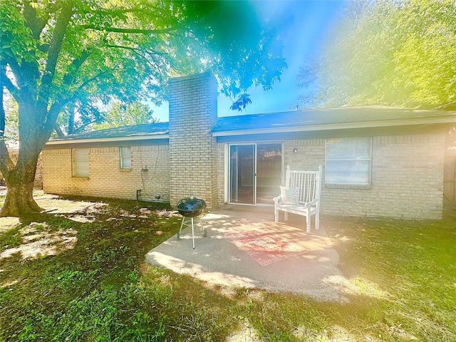 3317 Hummingbird, Denton, TX 76209 - rear view of house with a chimney, brick siding, and a patio area