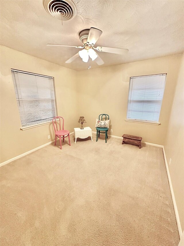 1008 Sierra Dr, Denton, TX 76209 - unfurnished room featuring baseboards, carpet flooring, a ceiling fan, and a textured ceiling