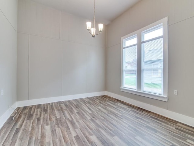 500 N Virginia St, Terrell, TX 75160 - spare room with a chandelier, wood finished floors, and baseboards