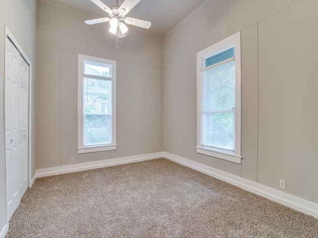 500 N Virginia St, Terrell, TX 75160 - unfurnished bedroom with carpet floors, a closet, ceiling fan, baseboards, and a decorative wall