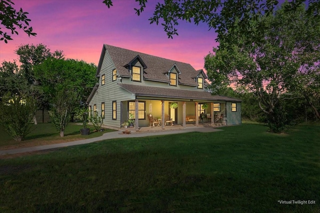 807 Berger Rd, West, TX 76691 - back of house at dusk featuring a yard, covered porch, and roof with shingles