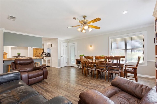 807 Berger Rd, West, TX 76691 - living area featuring a ceiling fan, crown molding, dark wood finished floors, and baseboards