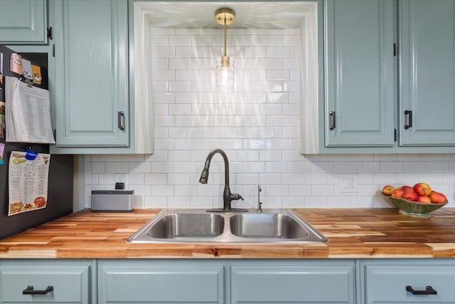 807 Berger Rd, West, TX 76691 - kitchen with butcher block counters, a sink, and tasteful backsplash