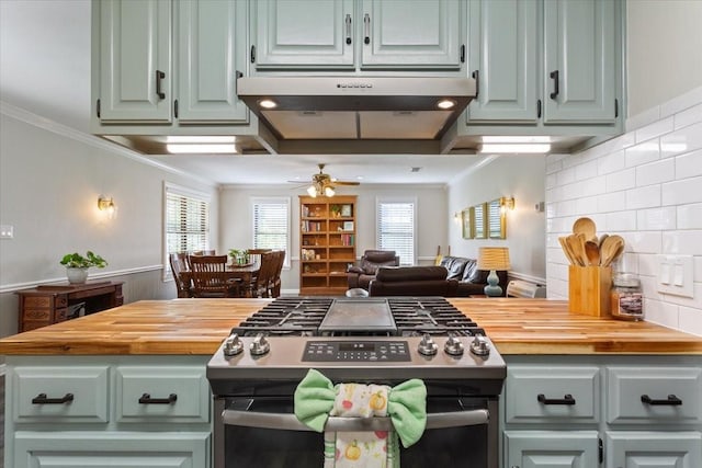 807 Berger Rd, West, TX 76691 - kitchen with stainless steel range with gas stovetop, butcher block countertops, a ceiling fan, ornamental molding, and tasteful backsplash
