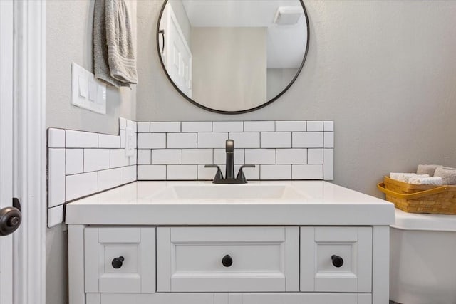807 Berger Rd, West, TX 76691 - bathroom featuring vanity, toilet, and backsplash
