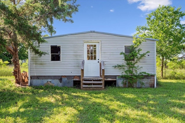 807 Berger Rd, West, TX 76691 - rear view of house with entry steps and a lawn