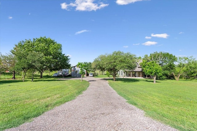 807 Berger Rd, West, TX 76691 - view of home's community featuring gravel driveway and a lawn