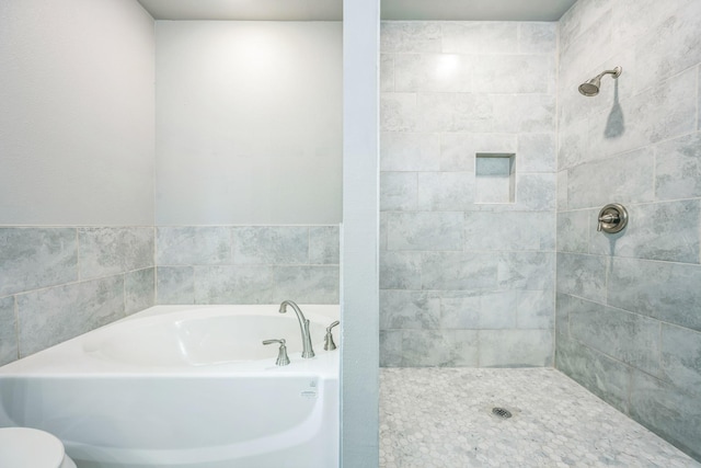 1729 Foster Dr, Arlington, TX 76012 - bathroom with a bath, a tile shower, and toilet
