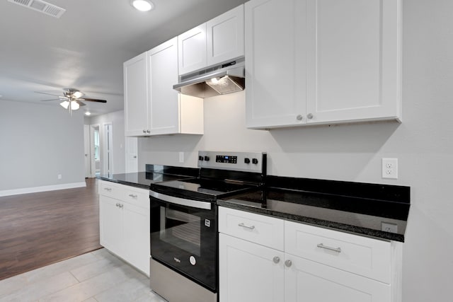 1729 Foster Dr, Arlington, TX 76012 - kitchen featuring stainless steel range with electric cooktop, under cabinet range hood, a ceiling fan, white cabinets, and baseboards