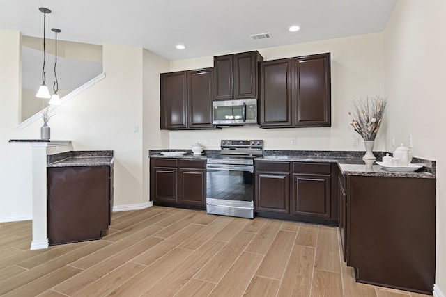 9016 N Stone Mill Ln, Fort Worth, TX 76179 - kitchen featuring appliances with stainless steel finishes, dark brown cabinetry, light wood-style floors, and recessed lighting