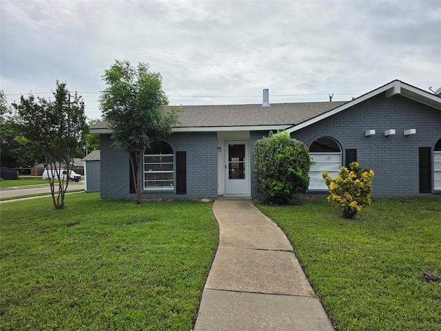 5501 Miami Dr, Rowlett, TX 75088 - single story home with brick siding, a front yard, and roof with shingles