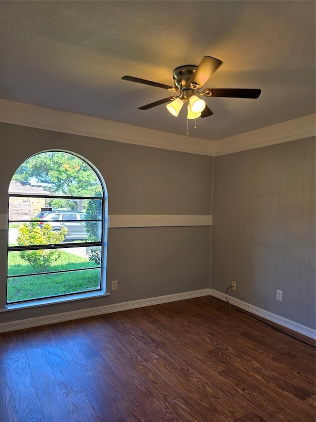 5501 Miami Dr, Rowlett, TX 75088 - empty room with dark wood finished floors, ceiling fan, and baseboards