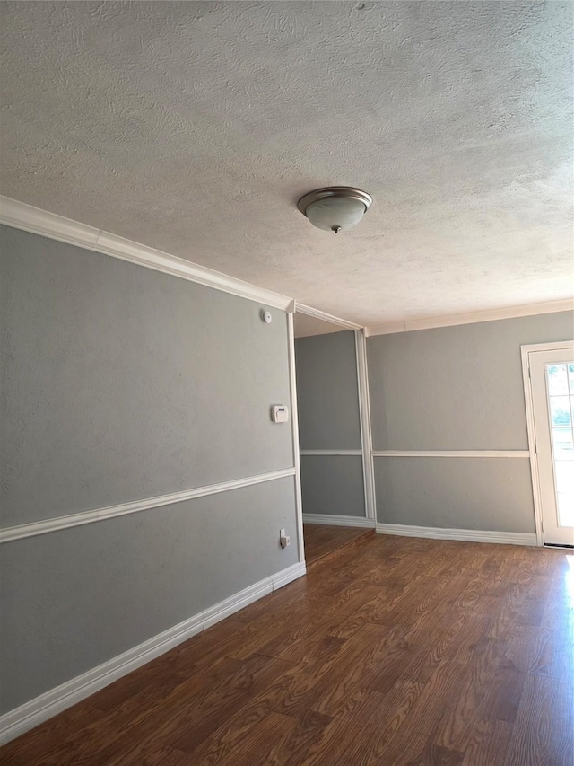 5501 Miami Dr, Rowlett, TX 75088 - unfurnished room with a textured ceiling, wood finished floors, crown molding, and baseboards