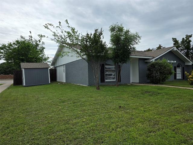 5501 Miami Dr, Rowlett, TX 75088 - view of front of house featuring a storage shed, a front yard, an outbuilding, and brick siding