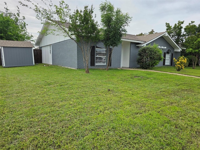 5501 Miami Dr, Rowlett, TX 75088 - view of front of home featuring a storage shed, a front yard, an outdoor structure, and brick siding