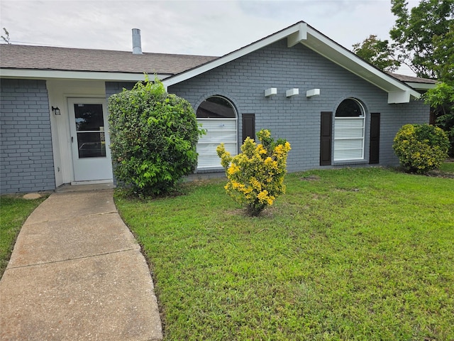 5501 Miami Dr, Rowlett, TX 75088 - view of front facade with brick siding and a front yard